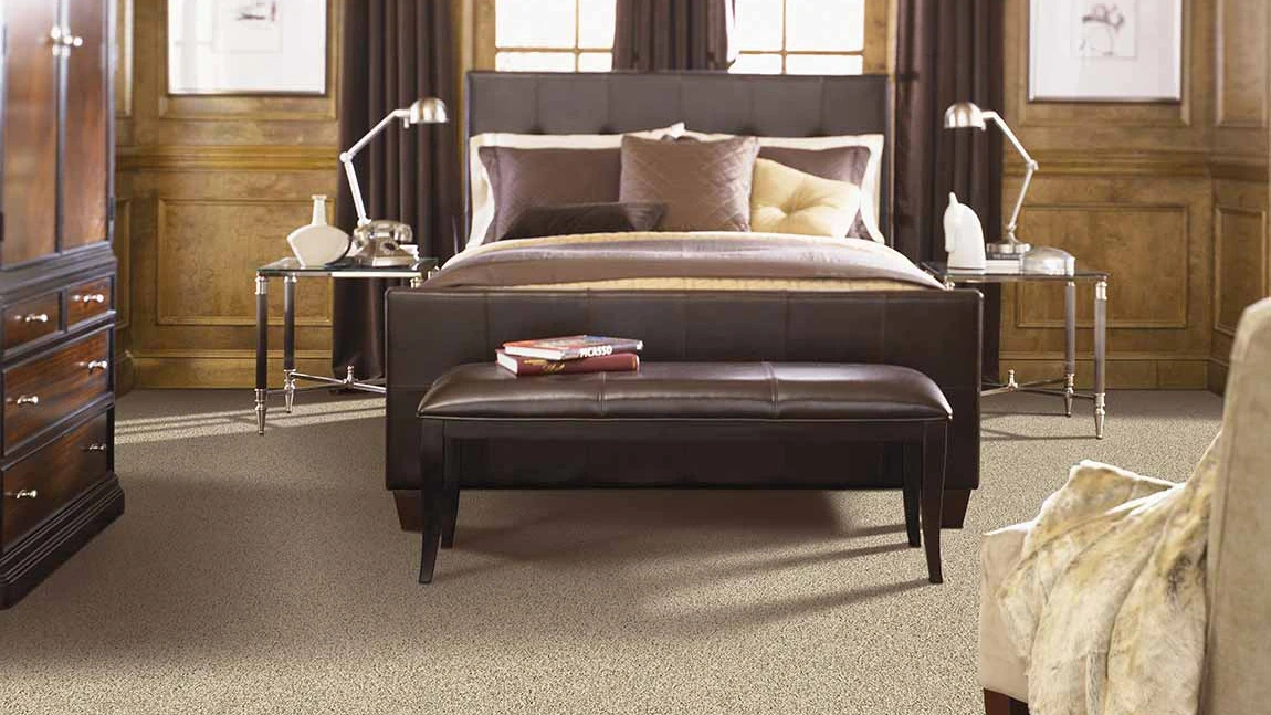 light carpet in wood paneled bedroom